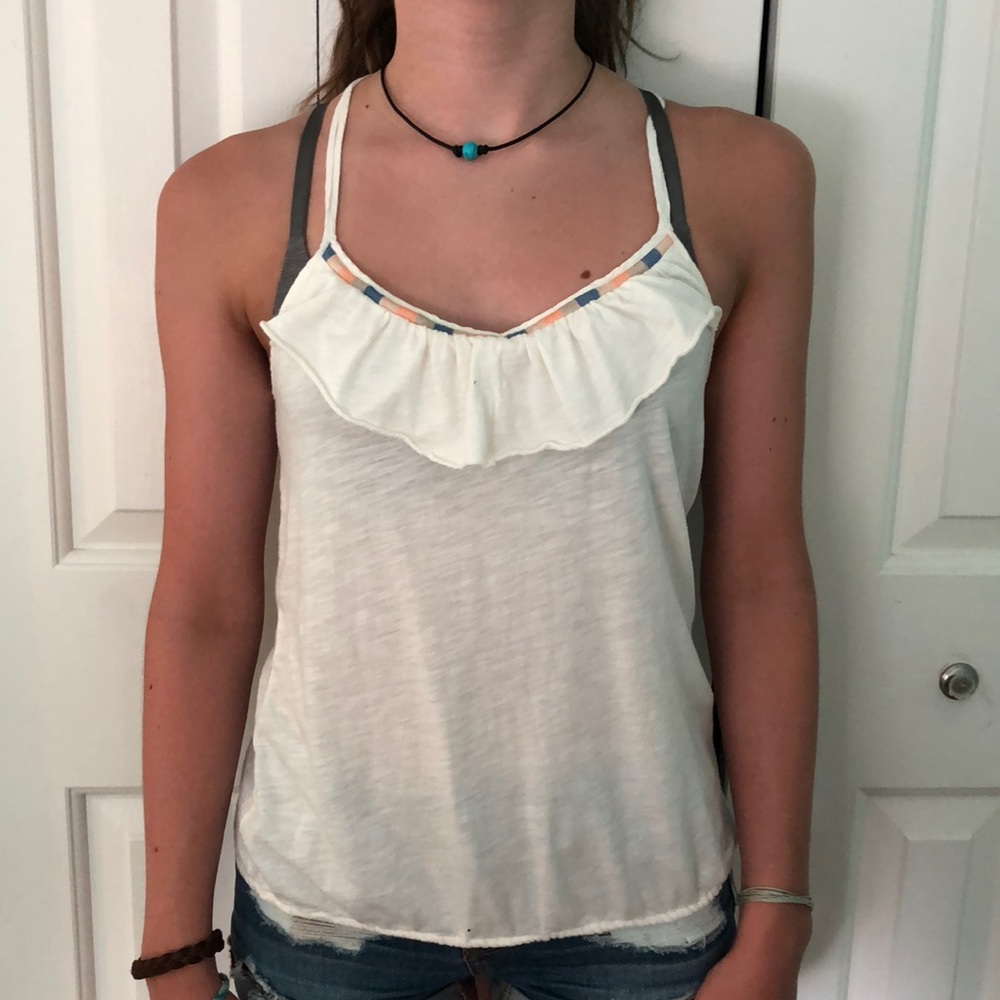 White tank with ruffle on top and colors